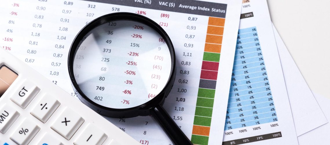 work-with-magnifying-glass-calculator-papers